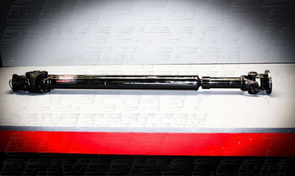 Black 1310 series driveshaft for 2007-2018 Jeep JK 2-door, featuring solid U-joints and pinion flanges, on a gray background.